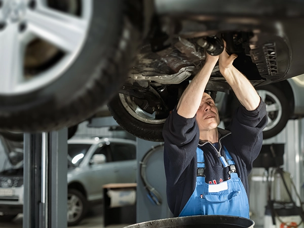technician working under car